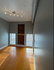 Bright, modern room with rich hardwood floors, sleek gray walls, and industrial lighting.
