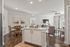Inviting open-concept living space with elegant dining area, bright kitchen island, and cozy seating at Legends at Laurel Canyon.
