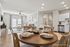 Elegant open-plan living space at Legends at Laurel Canyon featuring a stylish dining area, modern kitchen, and cozy living room with chic decor and natural light.
