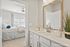 Inviting bedroom and bathroom with modern decor and abundant natural light, perfect for relaxed living.