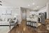 Elegant open-plan living room and kitchen area with modern furniture, cozy seating, and sleek stainless steel appliances, creating a welcoming atmosphere at Legends at Laurel Canyon.