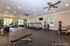 Spacious and well-lit fitness center with modern cardio and strength equipment, perfect for a comprehensive workout experience.