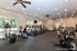 Spacious and modern fitness center with state-of-the-art equipment and scenic window views at Legends at North of Broad.