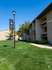 Serene Clear Point Gardens apartment community with lush green lawns and traditional architecture under a clear blue sky.