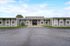 Contemporary single-story building with sleek design, large windows, and welcoming entrance.