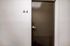 Modern apartment entryway featuring a sleek brown door with minimalist design labeled 'A4'.