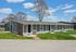 Charming single-story apartments with modern design, set in a peaceful suburban neighborhood with lush green lawns and mature trees.
