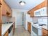 Galley Kitchen | White Appliances | Patriots Park Apartments
