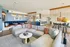 Spacious open-concept living room with modern decor, plush seating, and a stylish kitchen island.