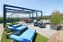 Chic rooftop patio with modern lounge chairs, hanging swings, and a scenic view, perfect for relaxation.