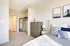 Bright, modern bedroom with elegant decor featuring soft lighting, a cozy bed, and ample closet space.