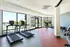 Stylishly designed gym with bright natural lighting, equipped with treadmills and exercise bikes.