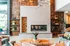 Stylish living room with modern fireplace, warm wooden accents, and chic decor items.