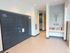 Modern apartment lobby featuring a convenient Amazon hub locker system and a cozy mini-library, perfect for urban living.