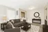 Modern living room with cozy seating, elegant decor, and built-in laundry area, perfect for stylish urban living.