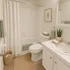 Inviting bathroom with elegant white fixtures, a cozy tub, and stylish green accents for a spa-like feel.