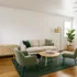 Inviting living room with modern beige sofa, green accent chairs, stylish rug, and abundant natural light.