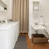 Chic laundry room with modern washer and dryer, elegant sink, and stylish wicker basket. Perfect blend of functionality and design.