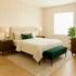 Elegant bedroom with a plush bed featuring green accents, flanked by chic wooden nightstands and ambient lighting, offering a serene and cozy atmosphere.