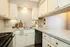 Sleek and modern kitchen with granite countertops, double sink, and stylish cabinetry, showcasing a cozy and inviting ambiance.