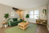 Charming living room with a modern design, featuring a cozy green sofa, elegant wood accents, and lush indoor plants for a refreshing ambiance.
