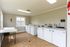 Spacious communal laundry room featuring modern washers and dryers in a well-lit, inviting atmosphere.