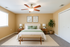 Elegant bedroom featuring a stylish bed with green accents, cozy lighting, and modern decor.