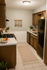 Cozy kitchen with wooden cabinetry, modern appliances, and inviting decor, perfect for culinary creativity.