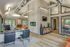 Leasing office with wood floors, large windows, wall art and chairs