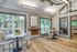 Leasing office with wood floors, large windows, wall art and chairs