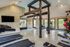 Fitness center with wood paneling, treadmills, TV, and ellipticals