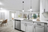 Kitchen with Vinyl floors, stainless-steel appliances, white quartz countertop, and pendant lighting.
