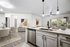 Kitchen with Vinyl floors, stainless-steel appliances, white quartz countertop, and pendant lighting.