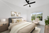 Bed with ceiling fan and window
