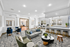 Resident lounge area with couch, kitchen bar, and chairs