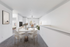 Living space with round dining table and chairs with kitchen bar