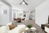Living room with couch,  coffee table, and ceiling fan
