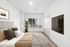 Carpeted bedroom, bed, TV window, and plant