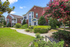 Exterior of brick apartment building with trees and sidewalk