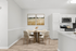 Dining table with chairs a plant and wall art