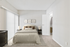 Bedroom with side table lamp, wall art, and sliding glass door