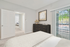 Bedroom with bed, dresser, and sliding glass patio door
