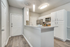 Kitchen with vinyl floors, stainless-steel appliances, granite countertop, and pendant lighting
