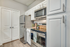 Kitchen with vinyl floors, stainless-steel appliances, granite countertop, and pendant lighting