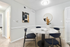 Dining table, chairs, and plants with wall art