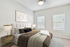 Bed, windows, and wall art