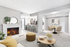 Carpeted living space with circular coffee table, fire place, and TV,