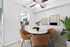 Dining area with ceiling fan, round table and chairs and wall art