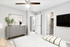 Carpeted bedroom with ceiling fan, beige bedding, dresser, and wall art.