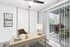Carpeted office space with desk, table lamp, chair, sliding closet doors, and sliding glass patio doors